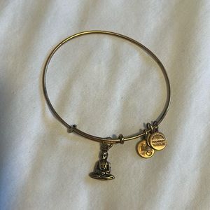 Worn gold Alex & Ani Buddha bracelet